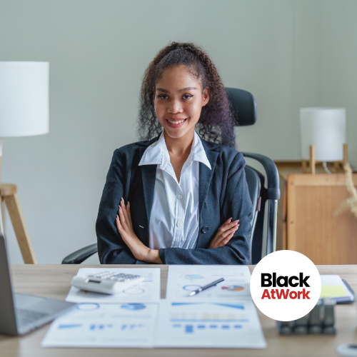 Black women looking excited and ready for business at her desk